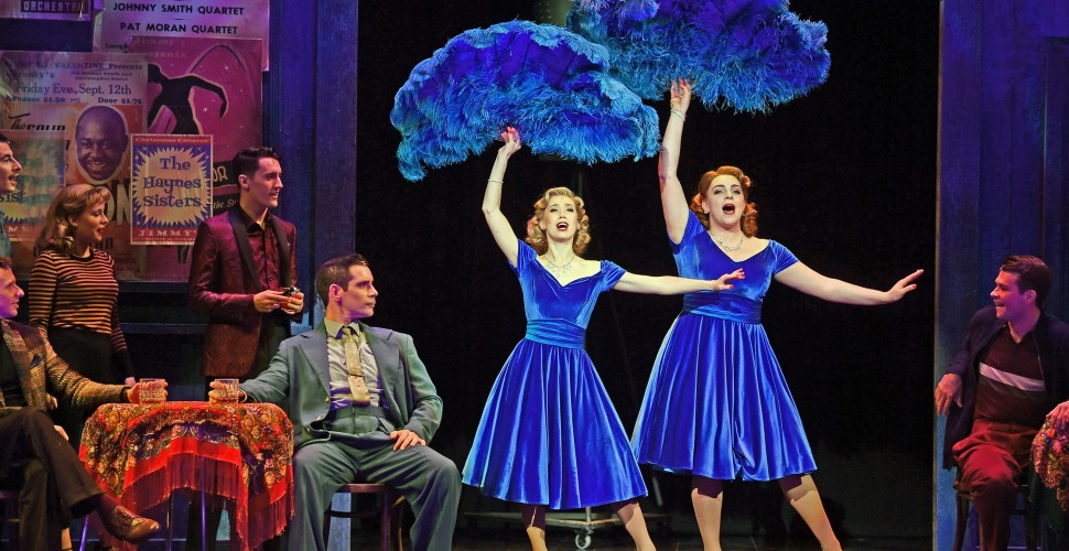 The cast of White Christmas dancing on stage